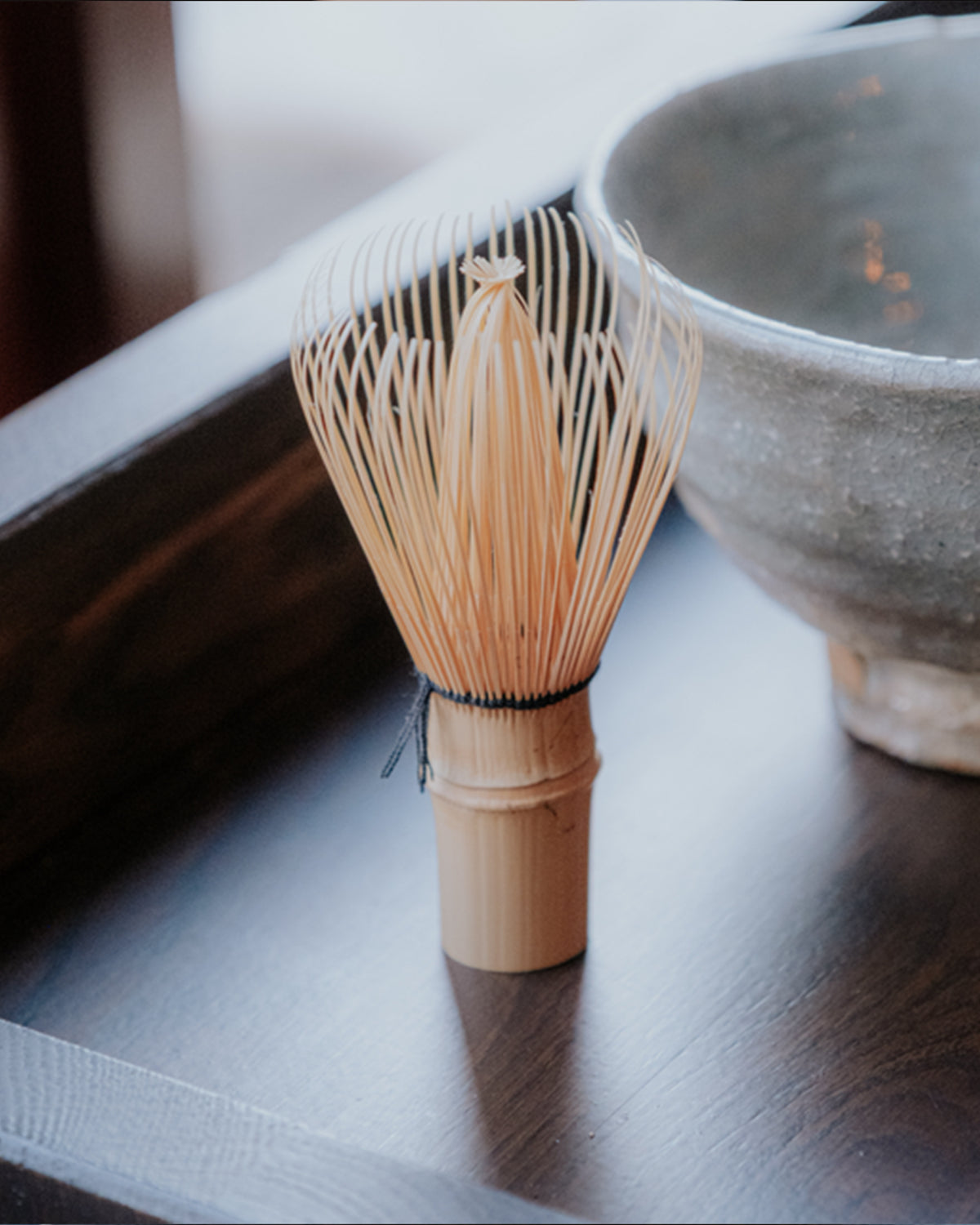 Bamboo whisk on tray