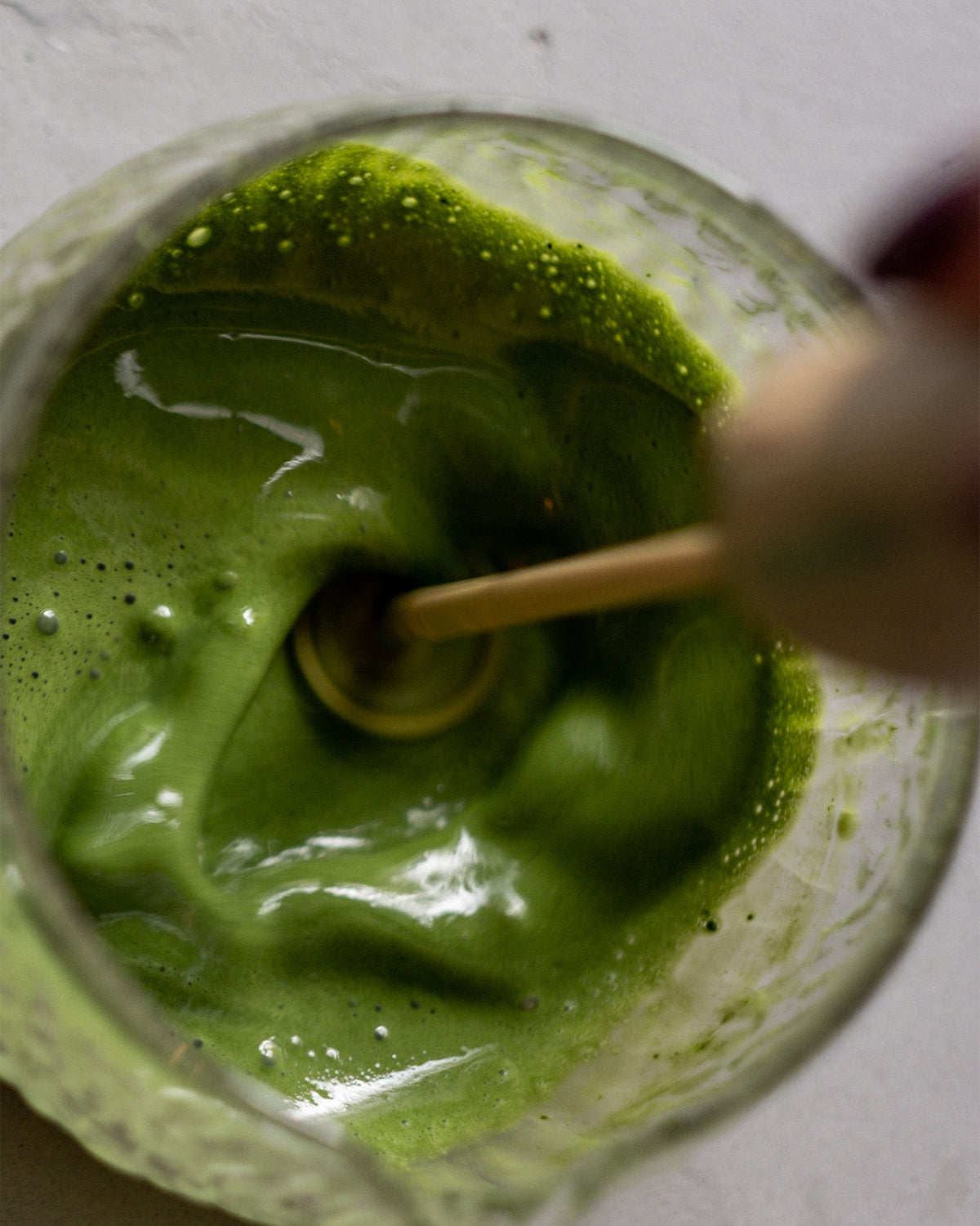 Electric matcha whisk in use, whisking matcha