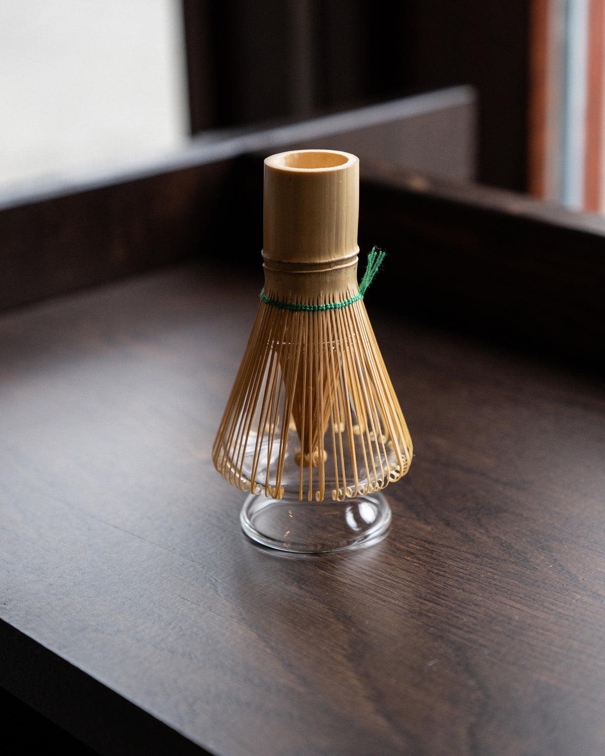 Kūkai whisk holder shown with a bamboo matcha whisk resting on it